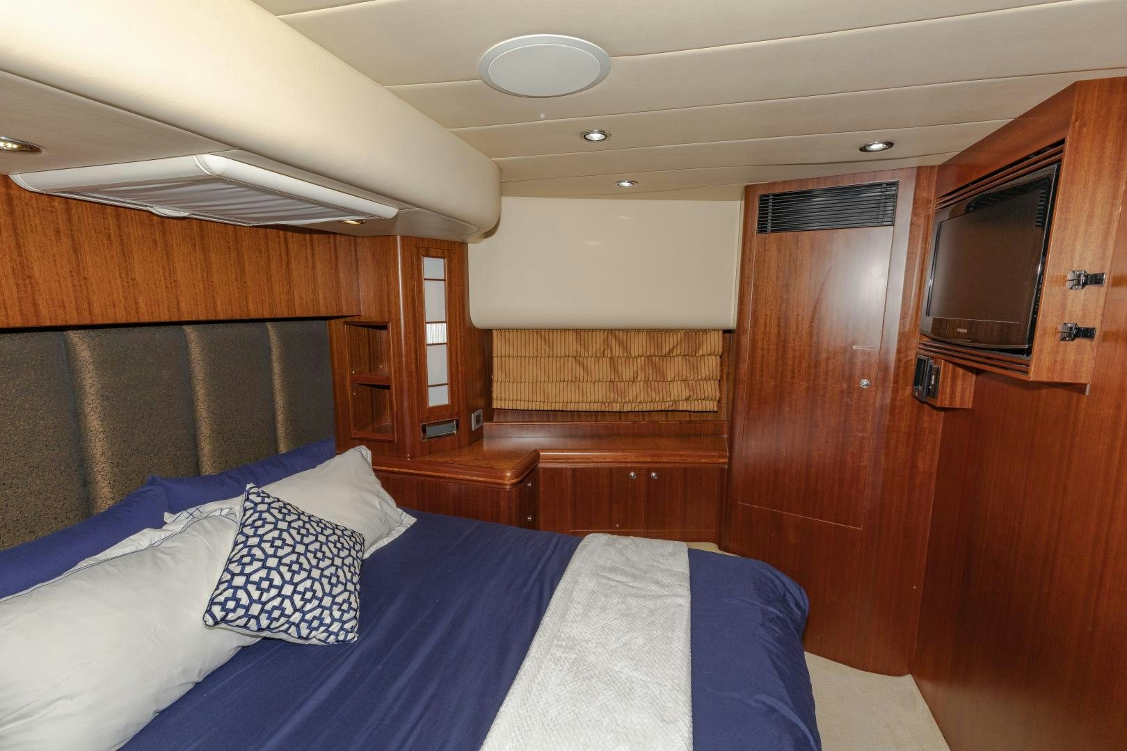 a room with a bed and a television aboard VIAGGIO Yacht for Sale