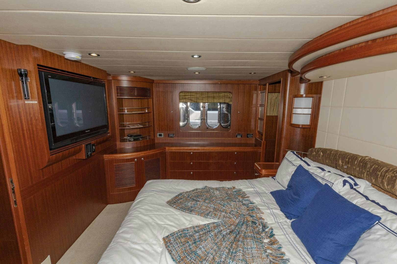 a bedroom with a bed and a television aboard VIAGGIO Yacht for Sale