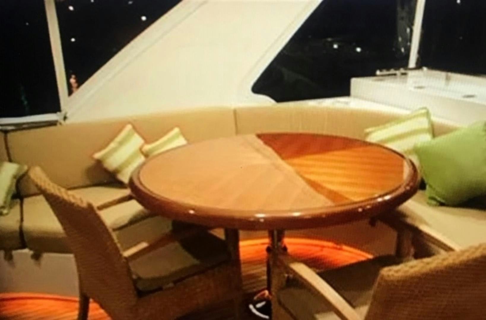 a table with chairs around it aboard VIAGGIO Yacht for Sale