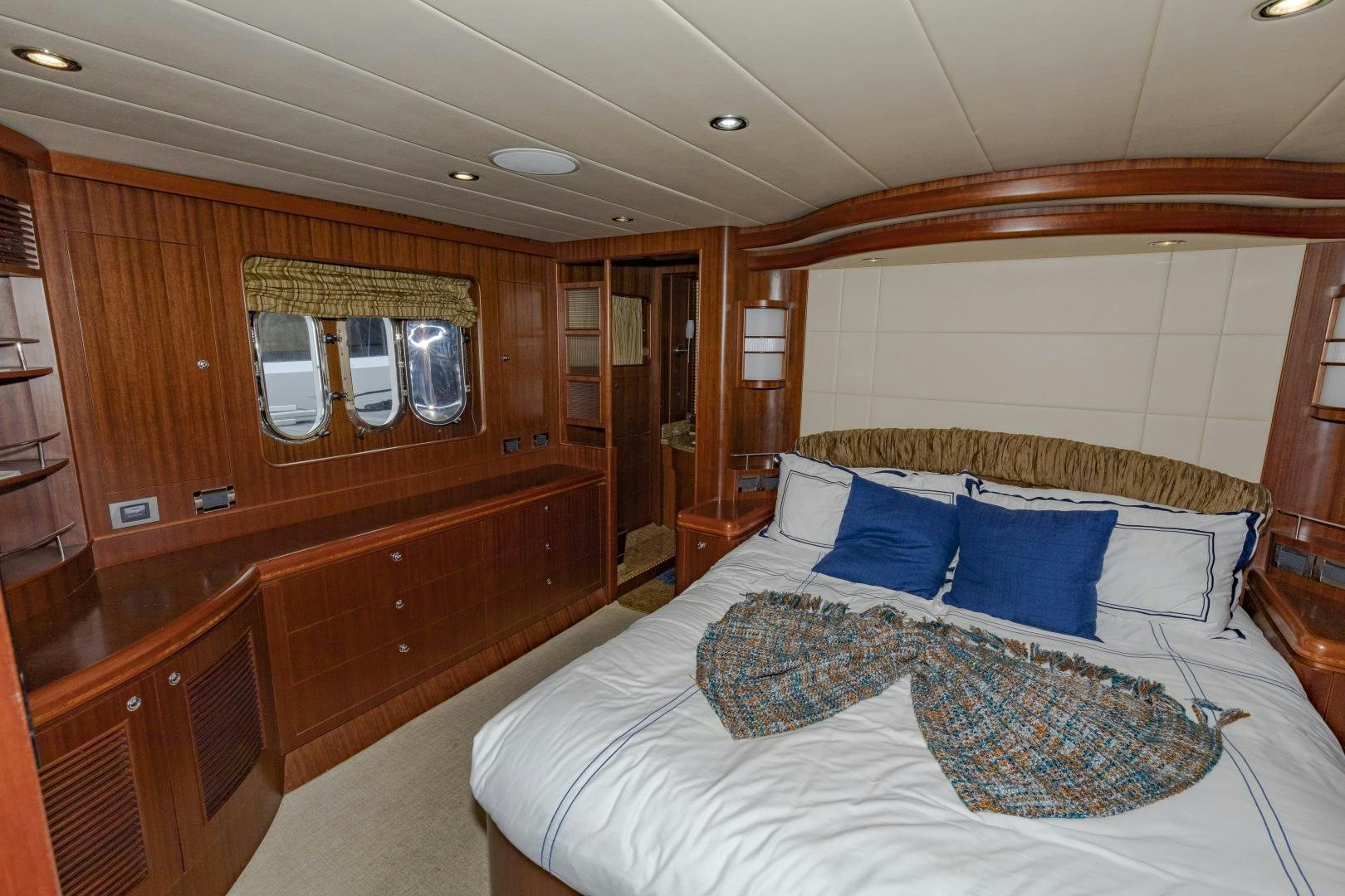 a bedroom with a bed and a mirror aboard VIAGGIO Yacht for Sale
