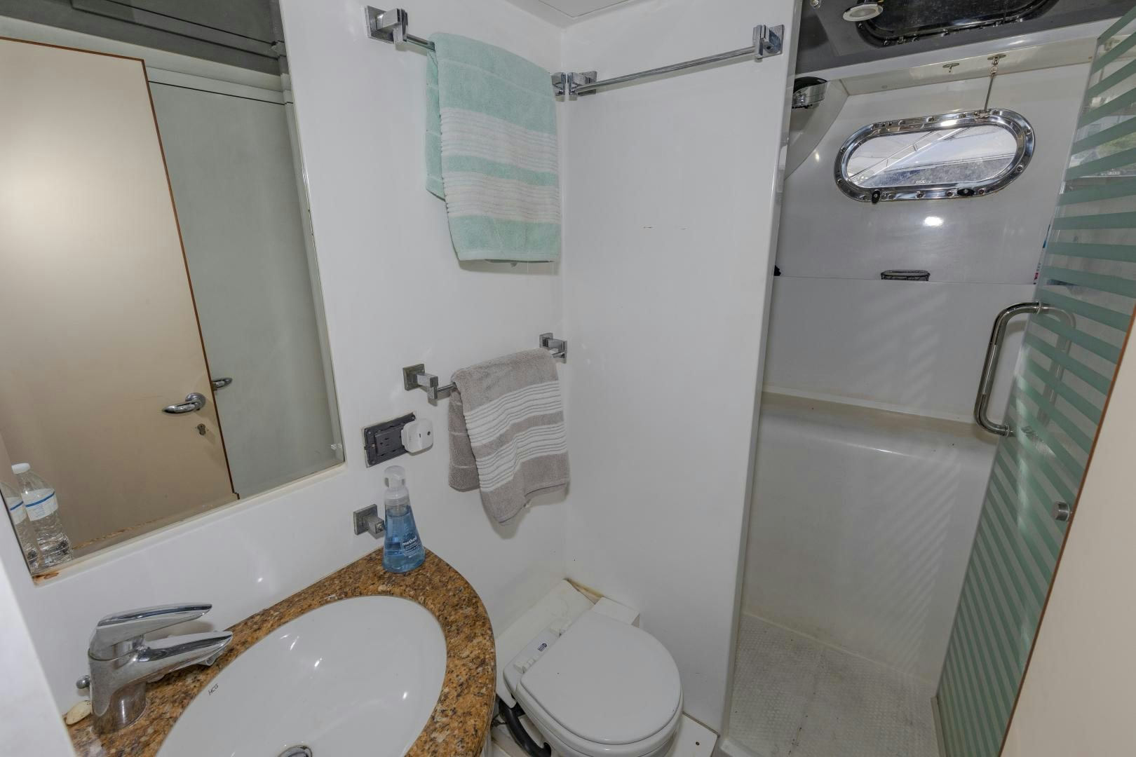 a bathroom with a countertop sink and a toilet aboard VIAGGIO Yacht for Sale