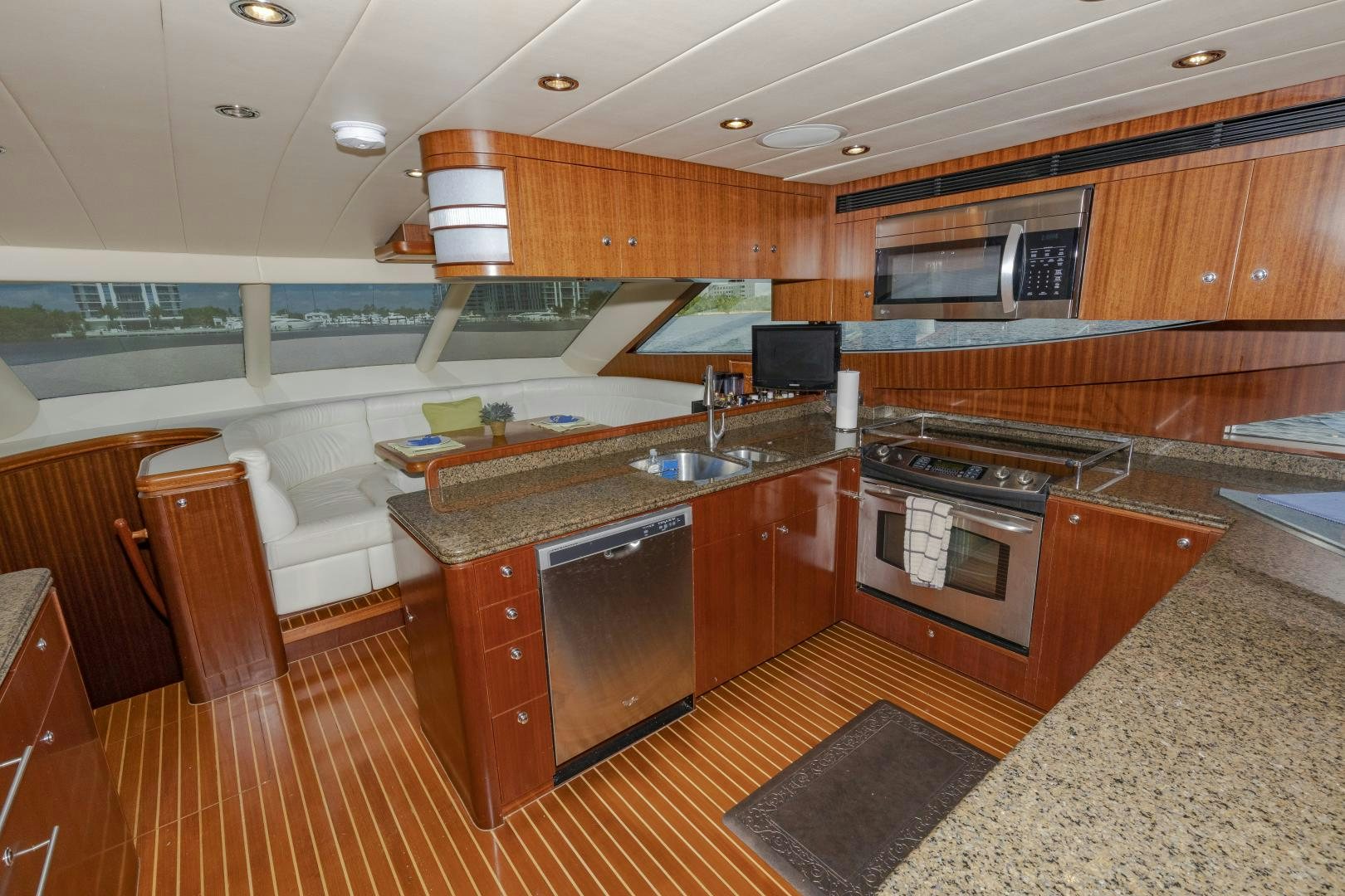 a kitchen with wooden cabinets aboard VIAGGIO Yacht for Sale