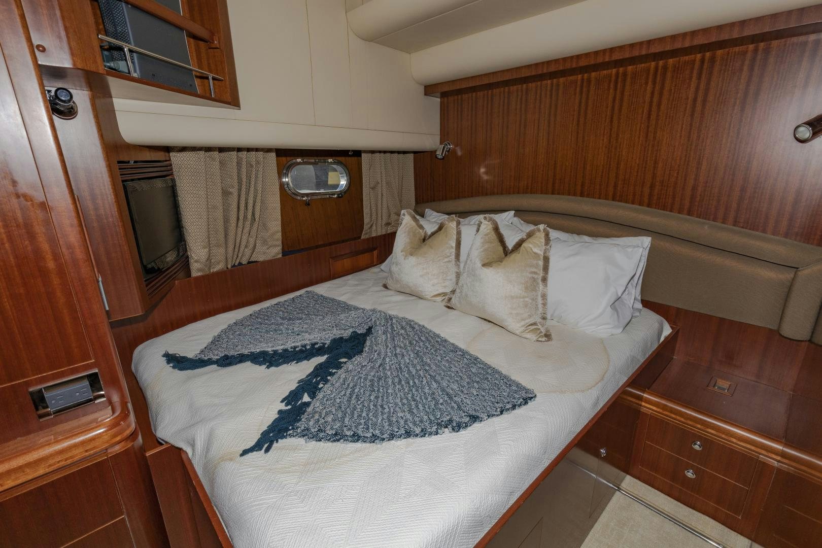a bed with a blue blanket aboard VIAGGIO Yacht for Sale