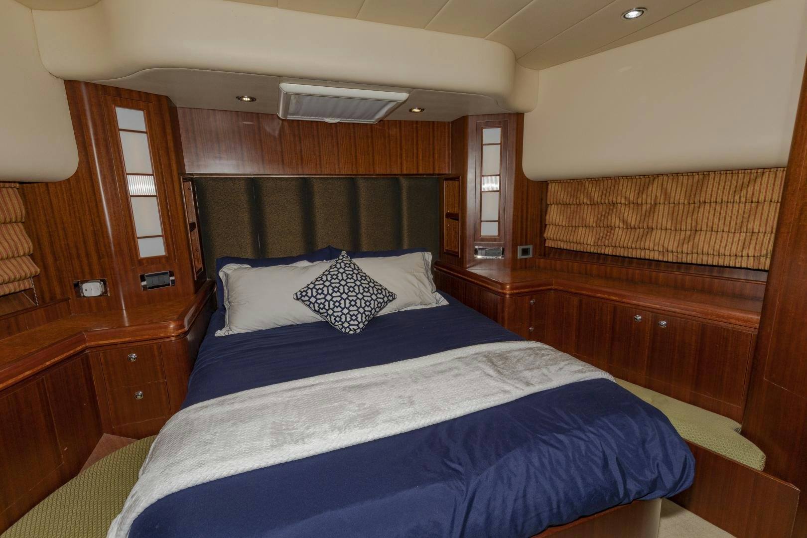 a bed with blue sheets aboard VIAGGIO Yacht for Sale
