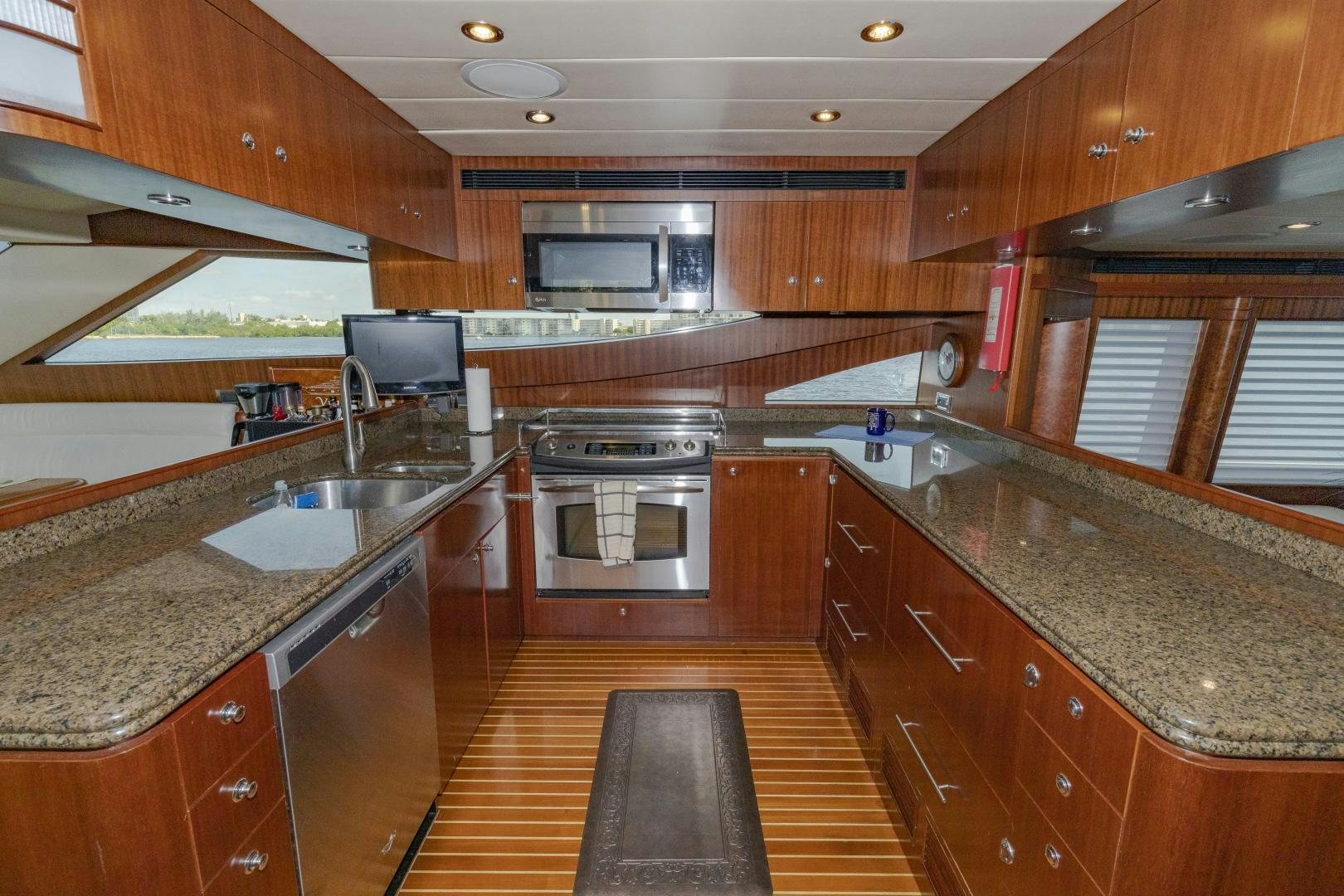 a kitchen with wooden cabinets aboard VIAGGIO Yacht for Sale