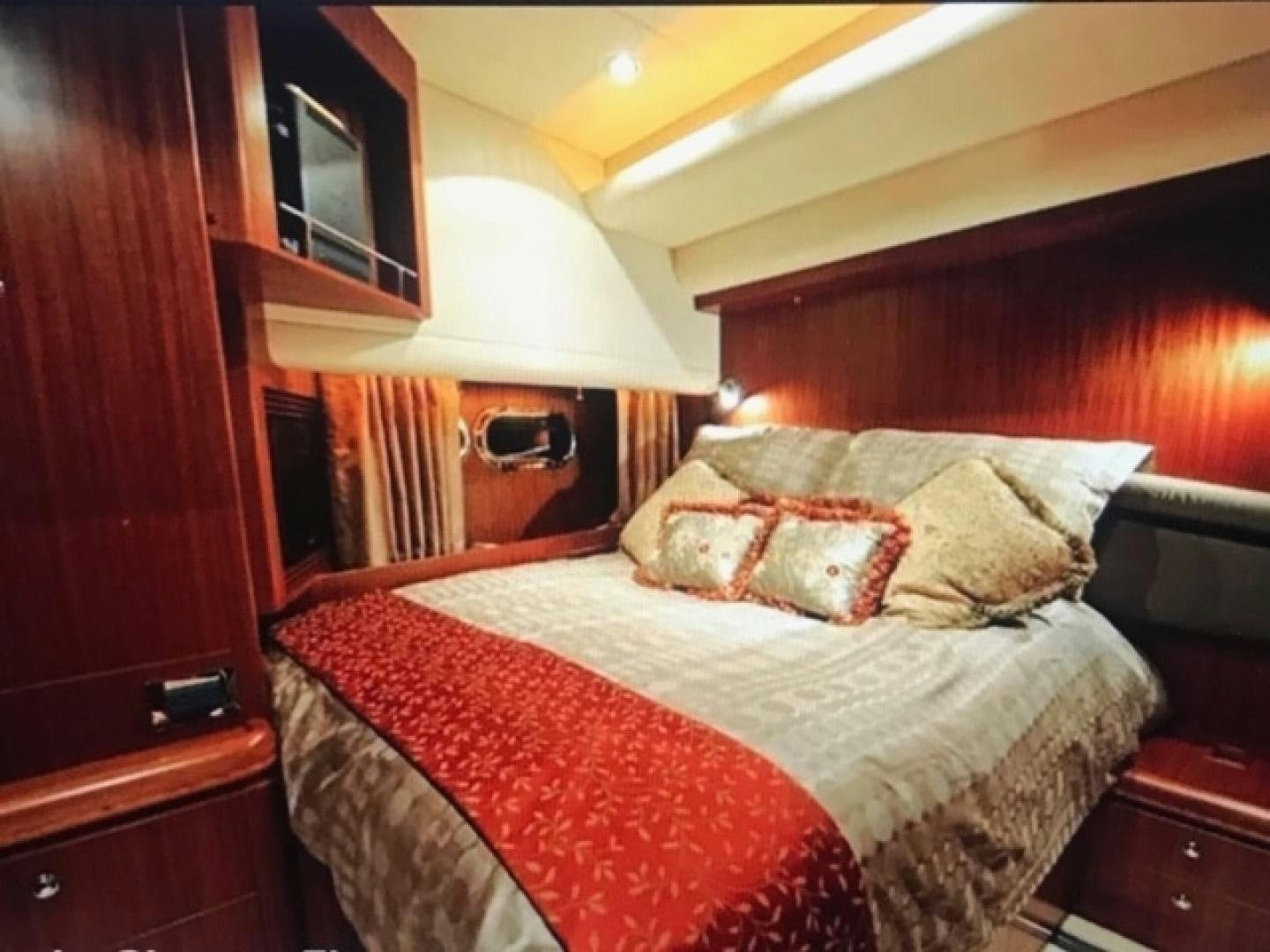 a bed with a red and white blanket aboard VIAGGIO Yacht for Sale