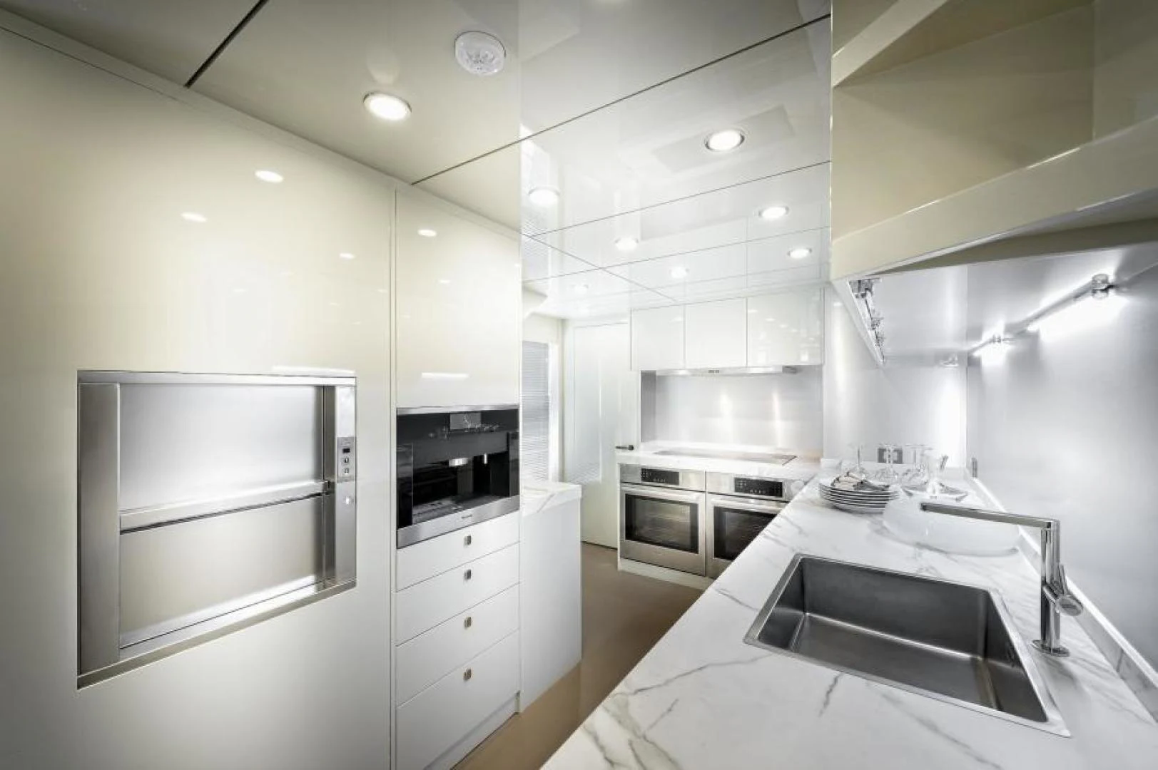 a kitchen with white cabinets aboard ZARANIA Yacht for Sale