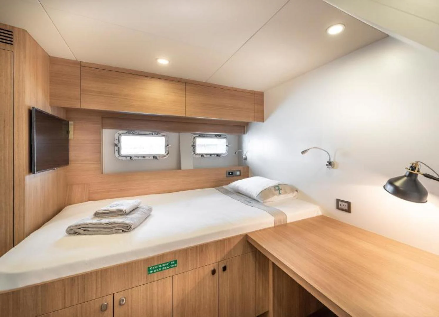 a bedroom with a bed and a television aboard ZARANIA Yacht for Sale