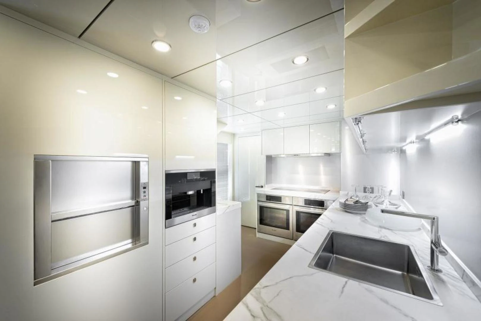 a kitchen with white cabinets aboard ZARANIA Yacht for Sale