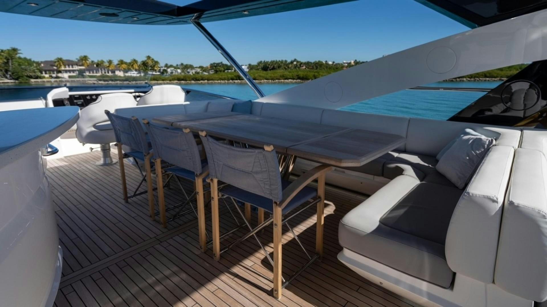 a deck with chairs and a boat on it aboard ENTERPRISE Yacht for Sale
