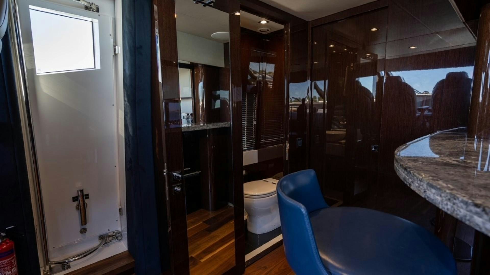 a bathroom with a blue chair aboard ENTERPRISE Yacht for Sale
