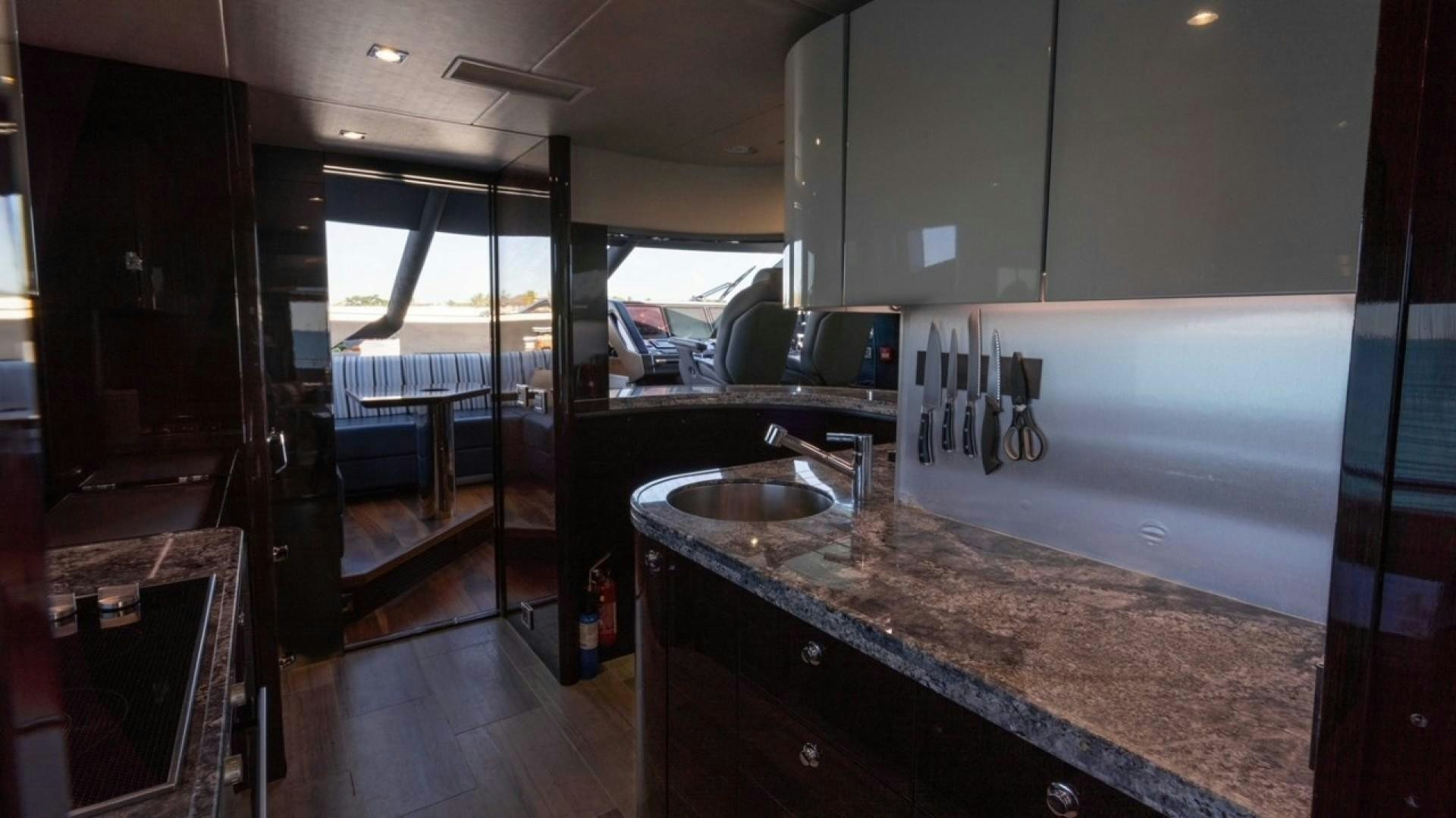 a kitchen with a countertop sink and a large island aboard ENTERPRISE Yacht for Sale