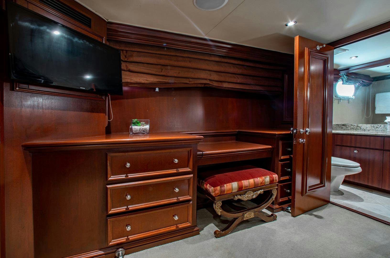 a room with a tv and dresser aboard THREE KINGS Yacht for Sale