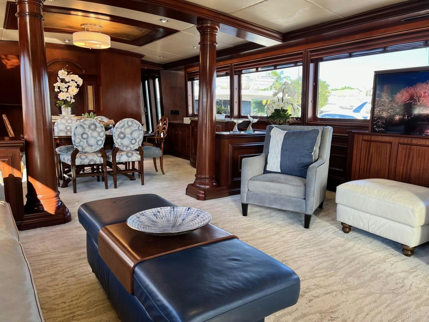 a living room with a wood table and chairs aboard THREE KINGS Yacht for Sale
