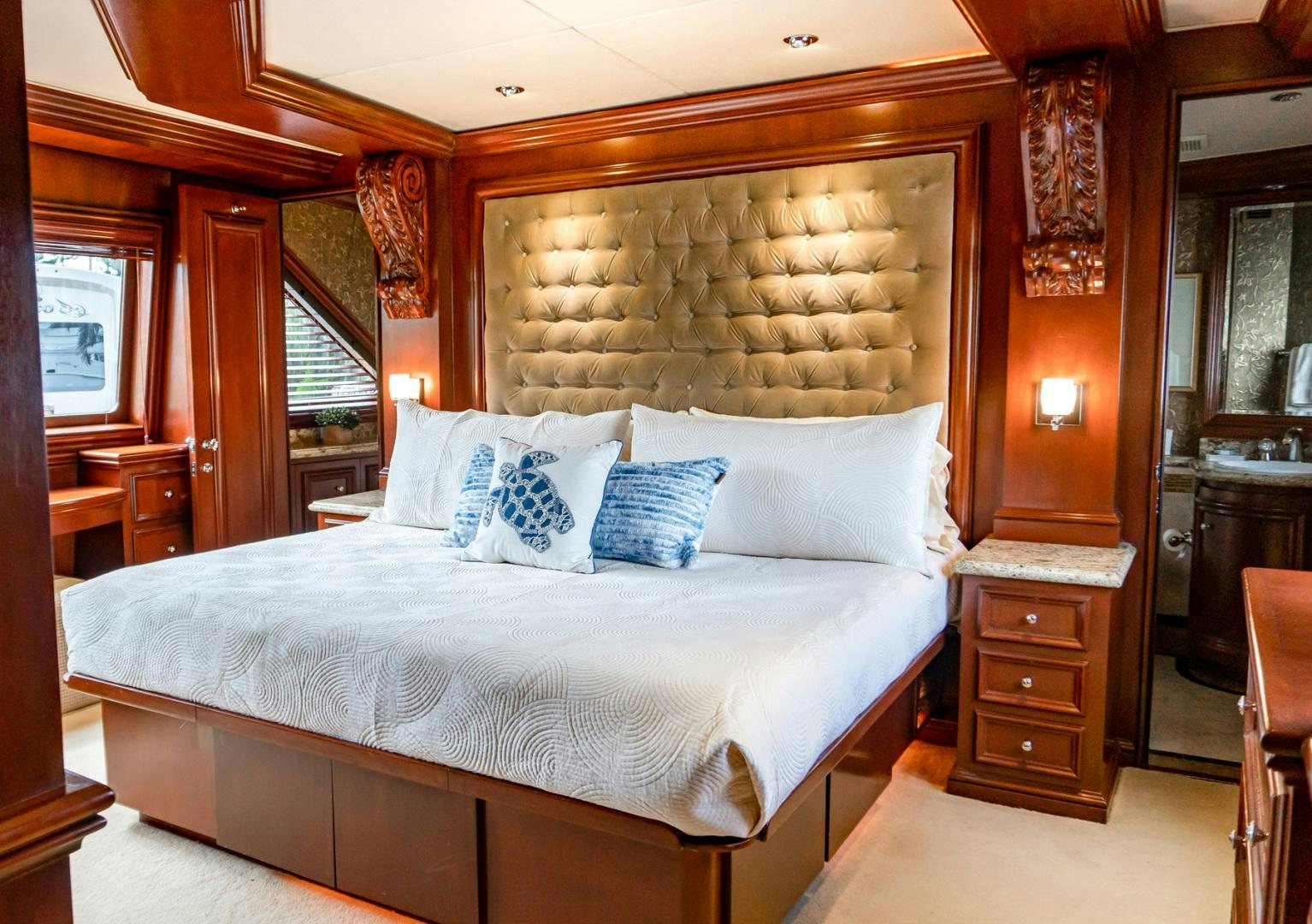 a bed with a pillow on it aboard THREE KINGS Yacht for Sale
