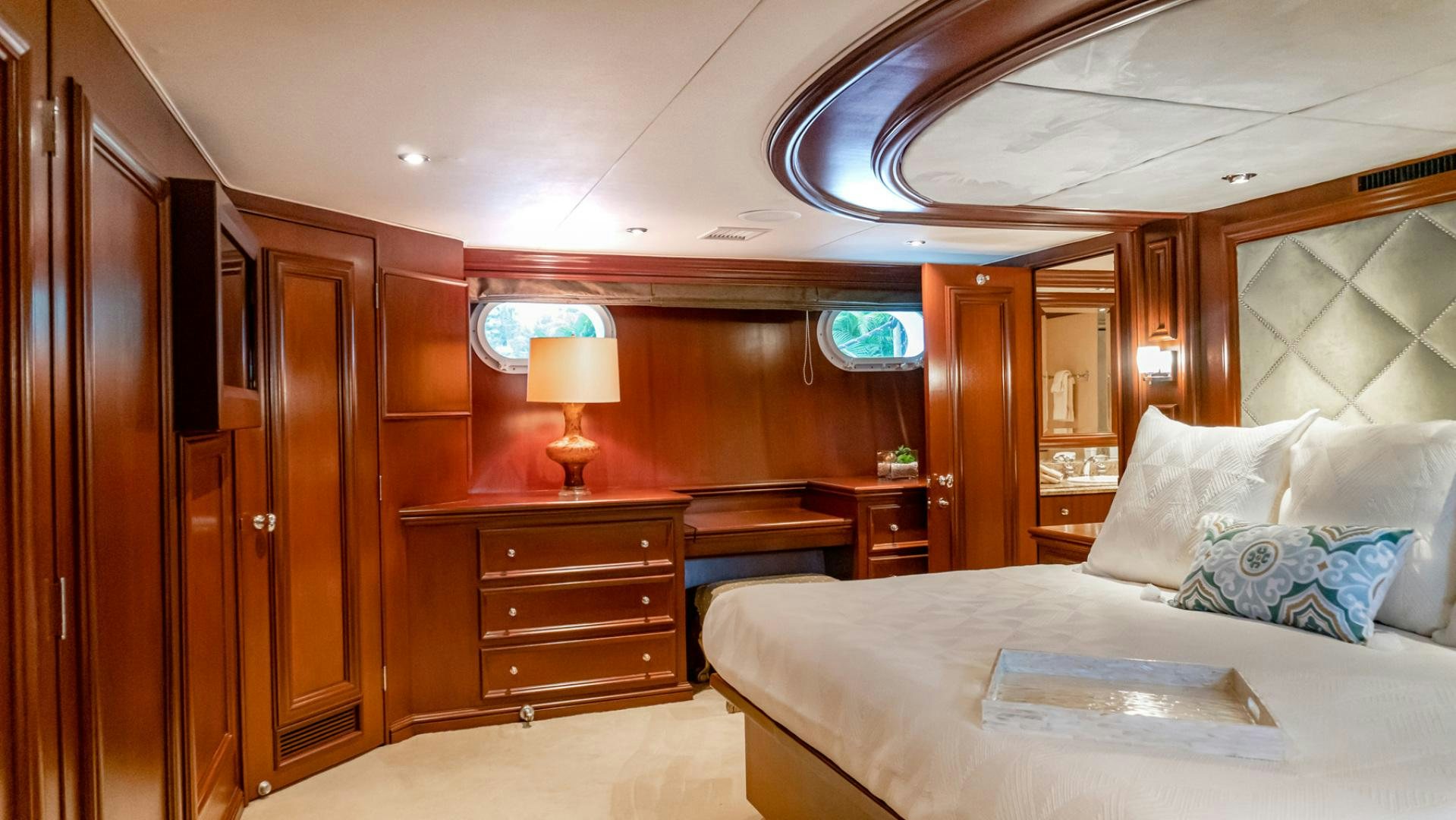 a bedroom with a bed and a desk aboard THREE KINGS Yacht for Sale
