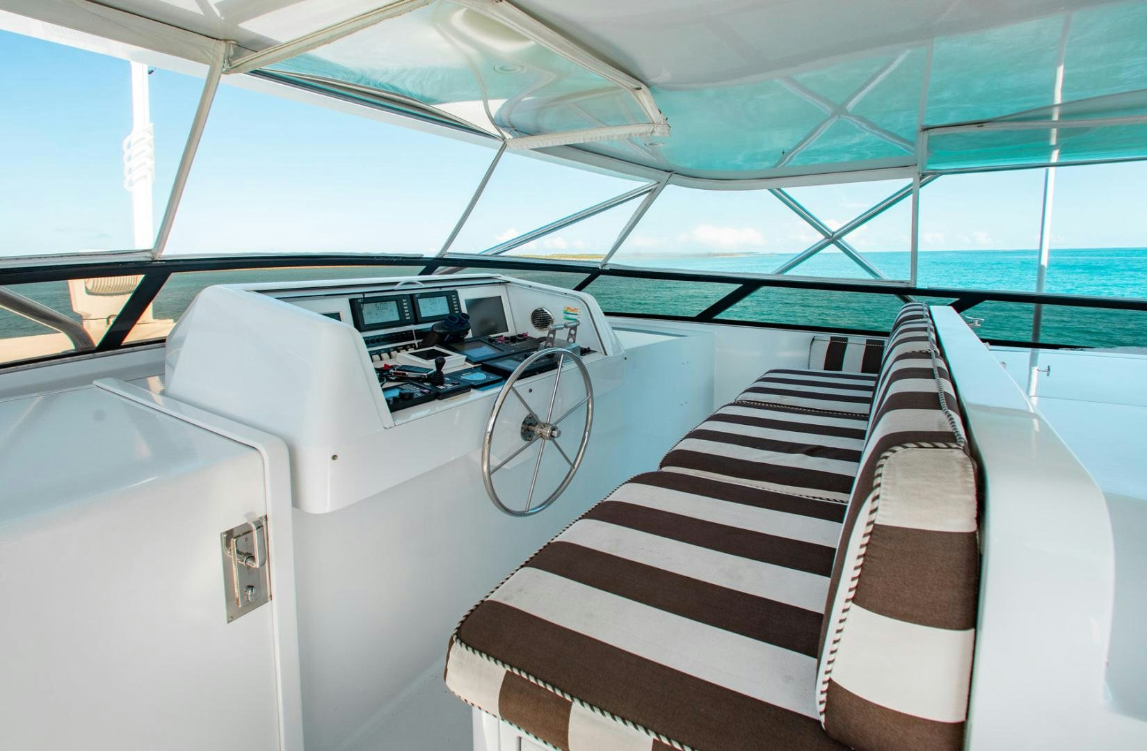 a boat with a striped seat aboard THREE KINGS Yacht for Sale