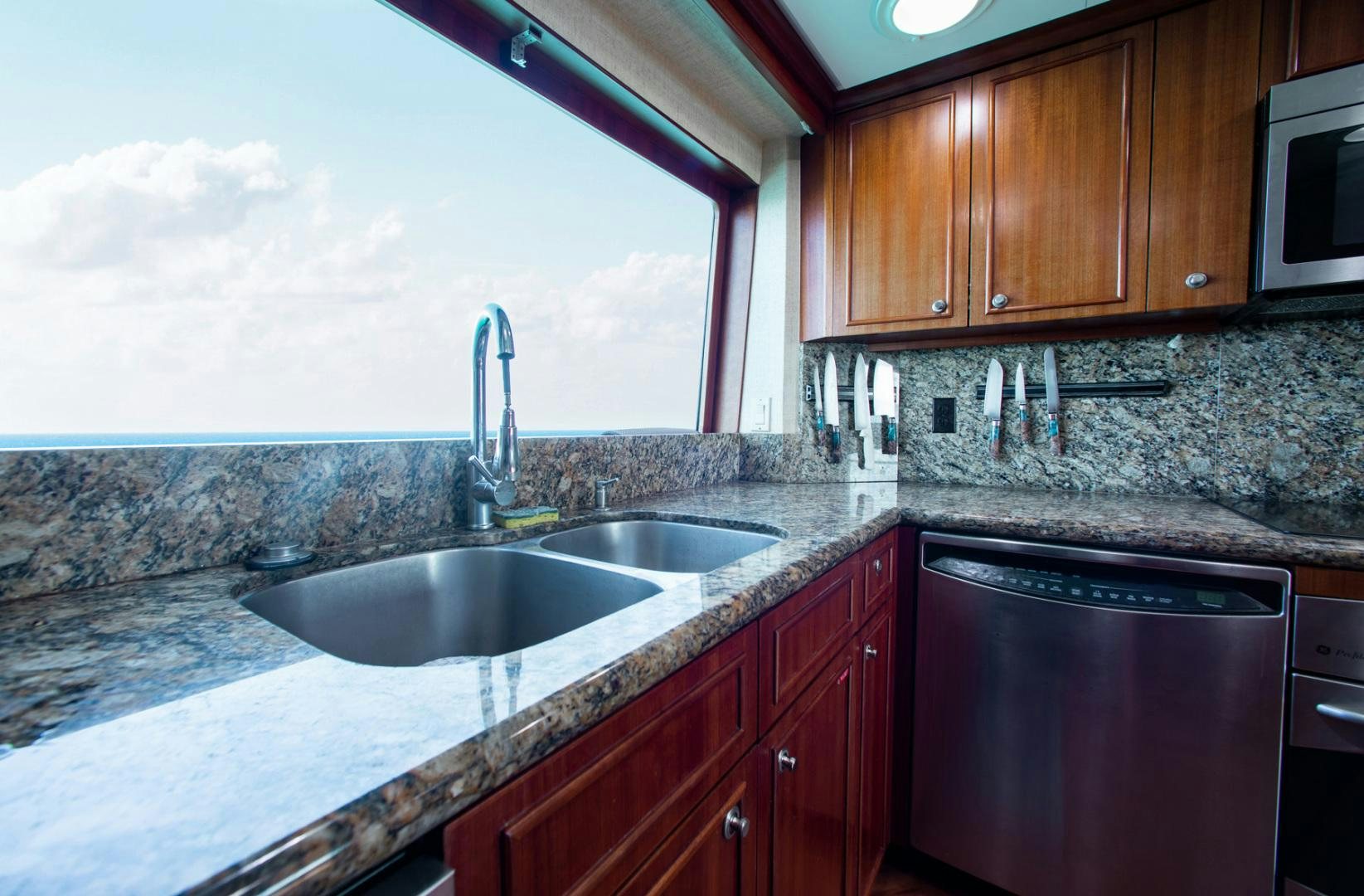 a kitchen with a large window aboard THREE KINGS Yacht for Sale