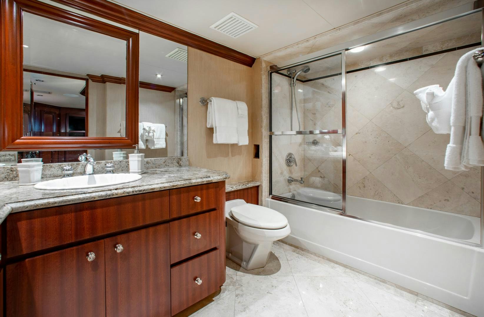 a bathroom with a bathtub and toilet aboard THREE KINGS Yacht for Sale