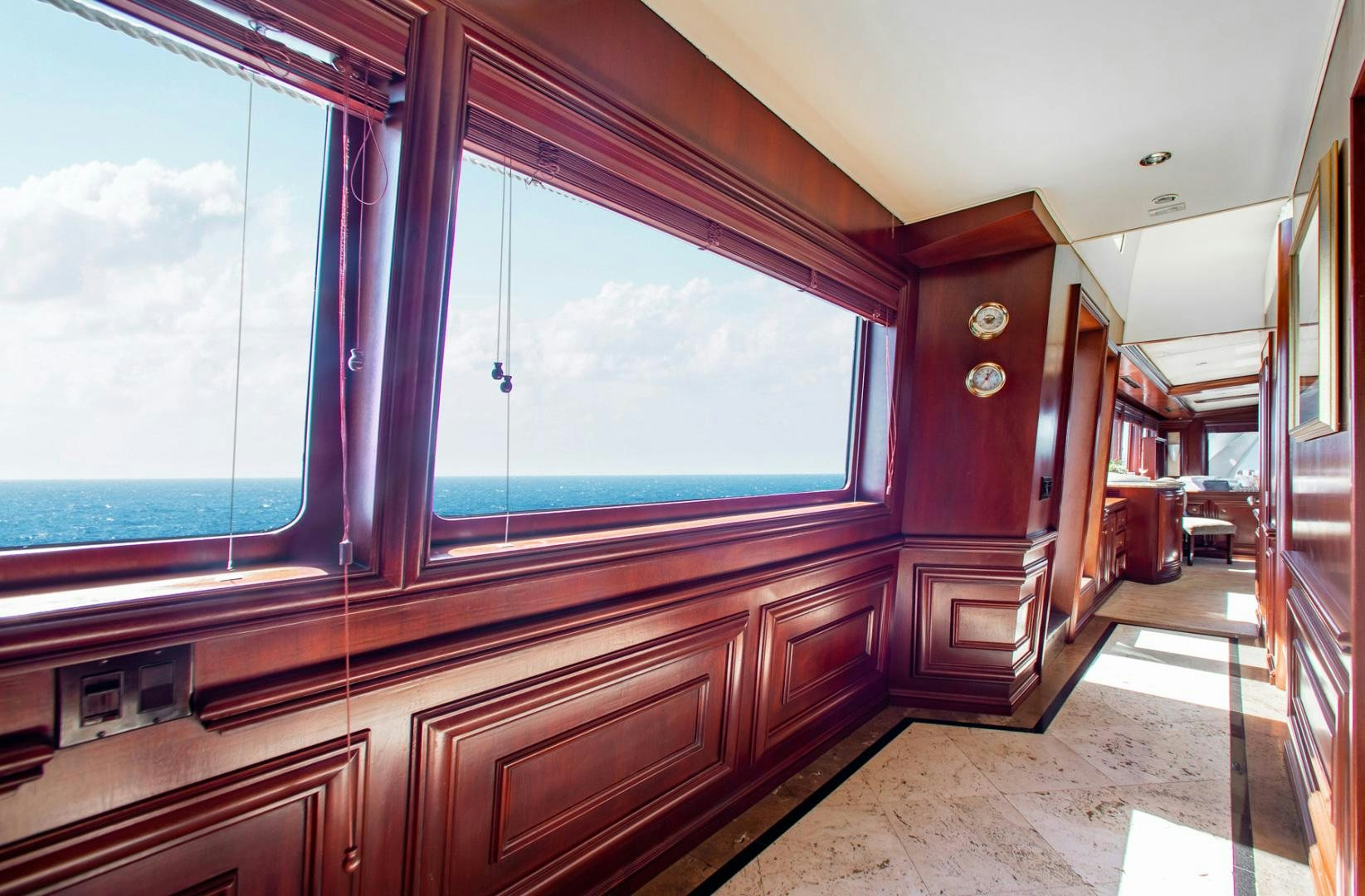 a room with a window and a wood cabinet aboard THREE KINGS Yacht for Sale
