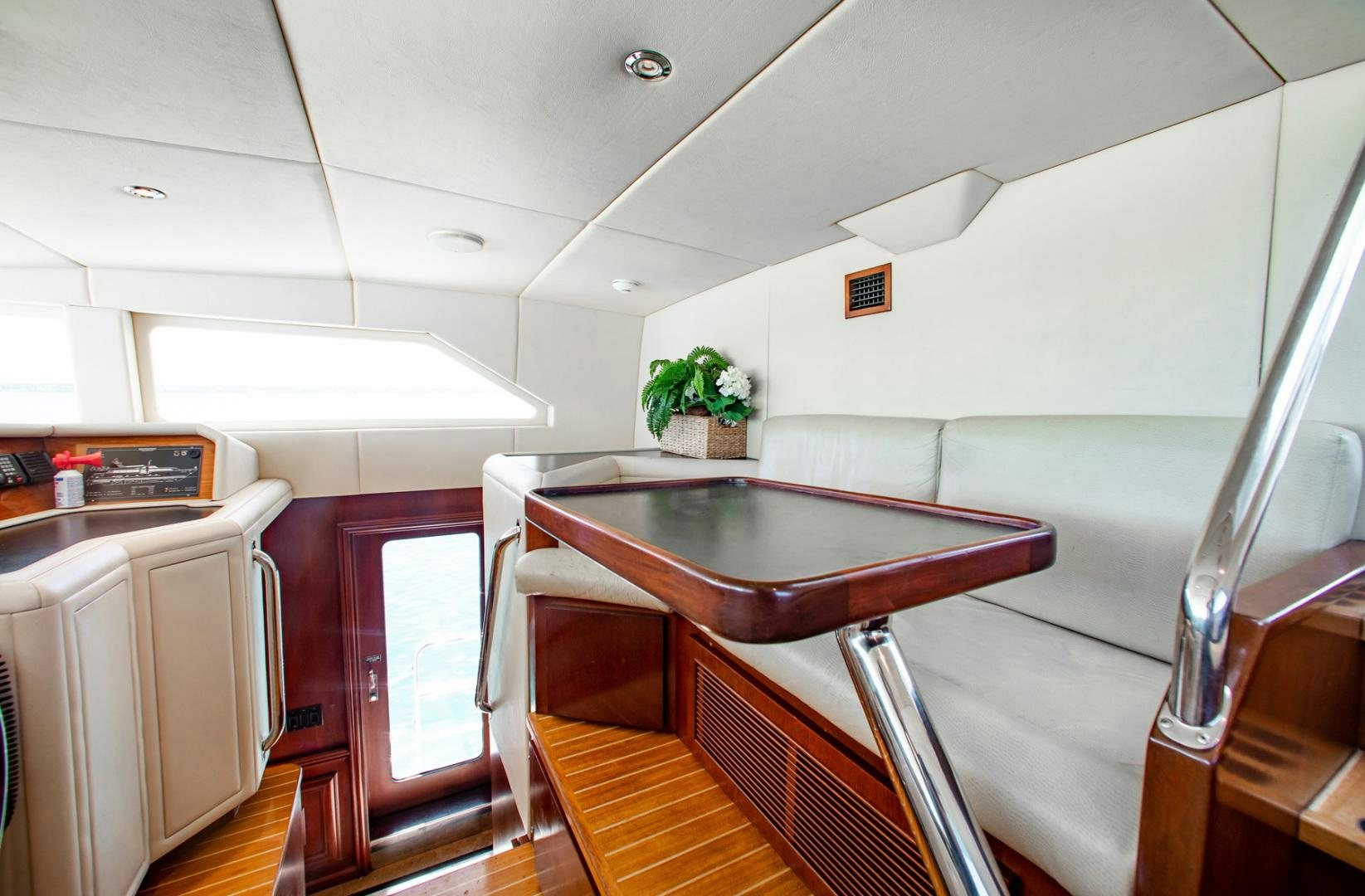 a kitchen with a table and chairs aboard THREE KINGS Yacht for Sale