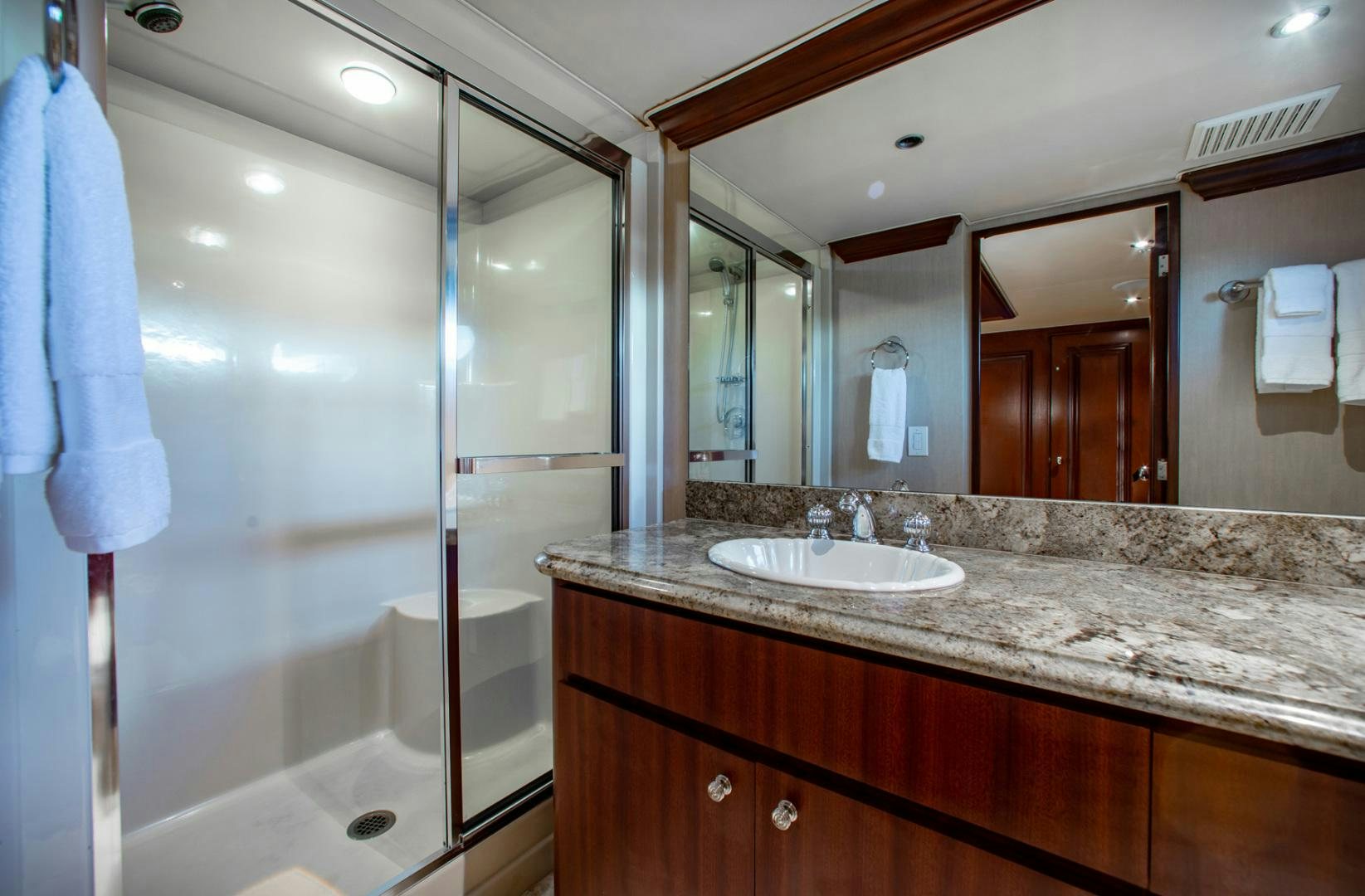 a bathroom with a glass shower aboard THREE KINGS Yacht for Sale