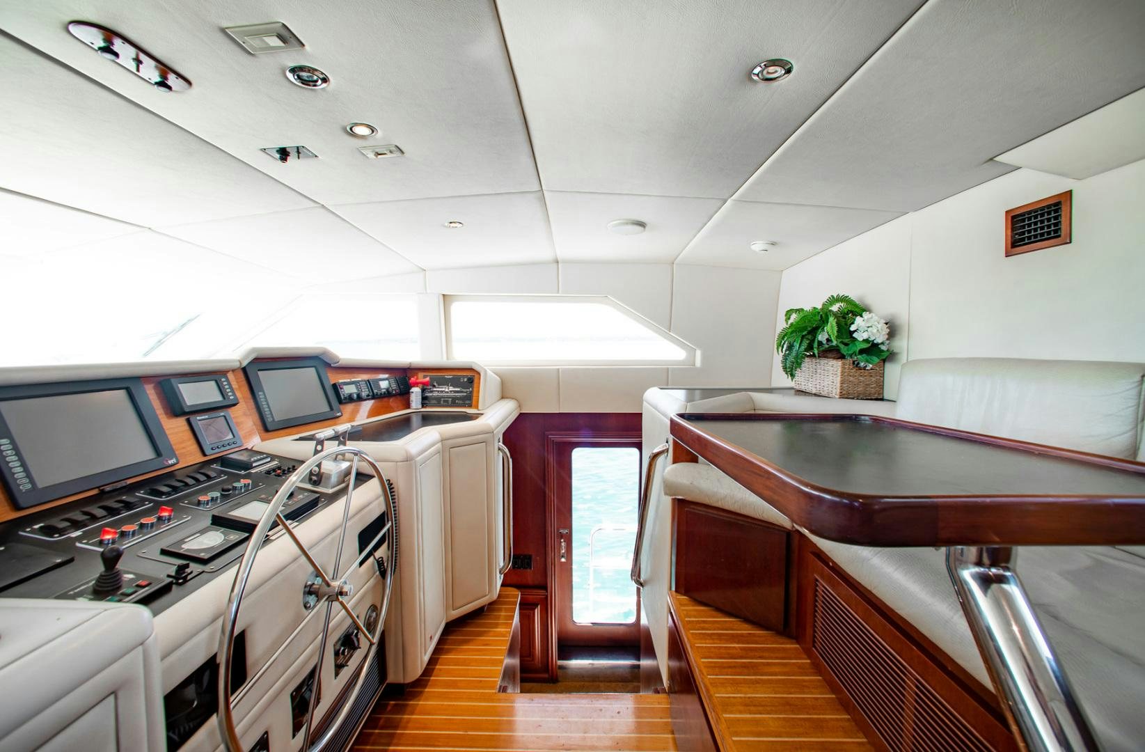 a kitchen with a table and chairs aboard THREE KINGS Yacht for Sale
