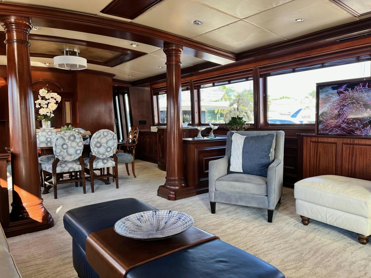 a living room with a wood table and chairs aboard THREE KINGS Yacht for Sale