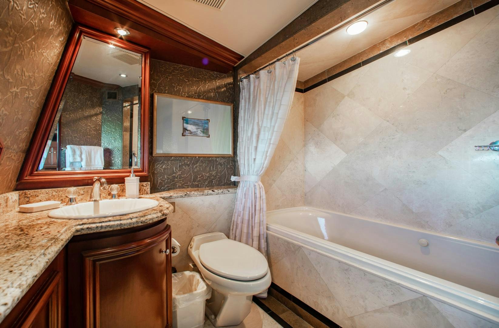 a bathroom with a sink toilet and a bathtub aboard THREE KINGS Yacht for Sale