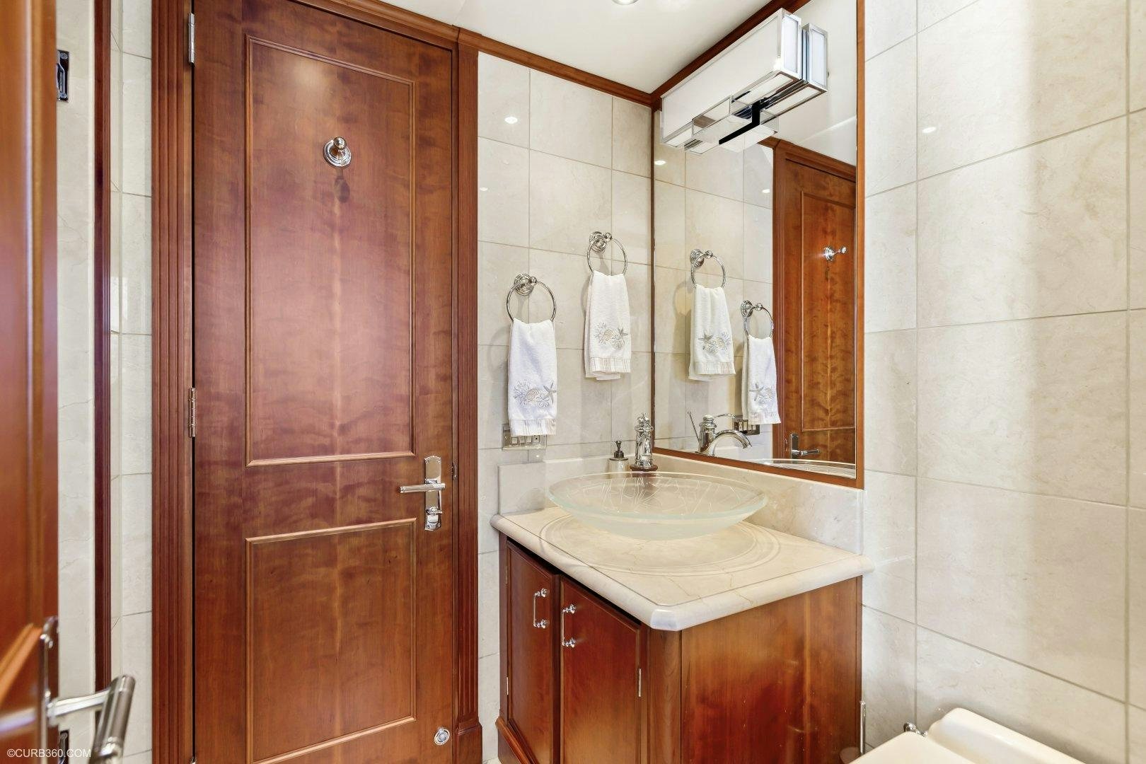 a bathroom with a sink and a mirror aboard APHRODITE Yacht for Sale