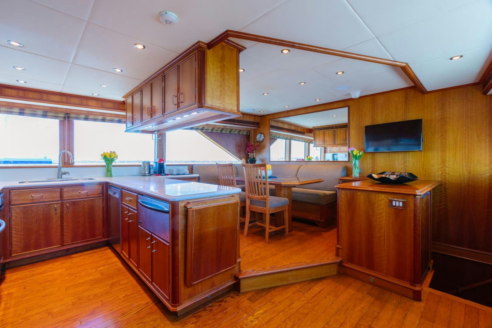 a kitchen with wooden cabinets aboard APHRODITE Yacht for Sale
