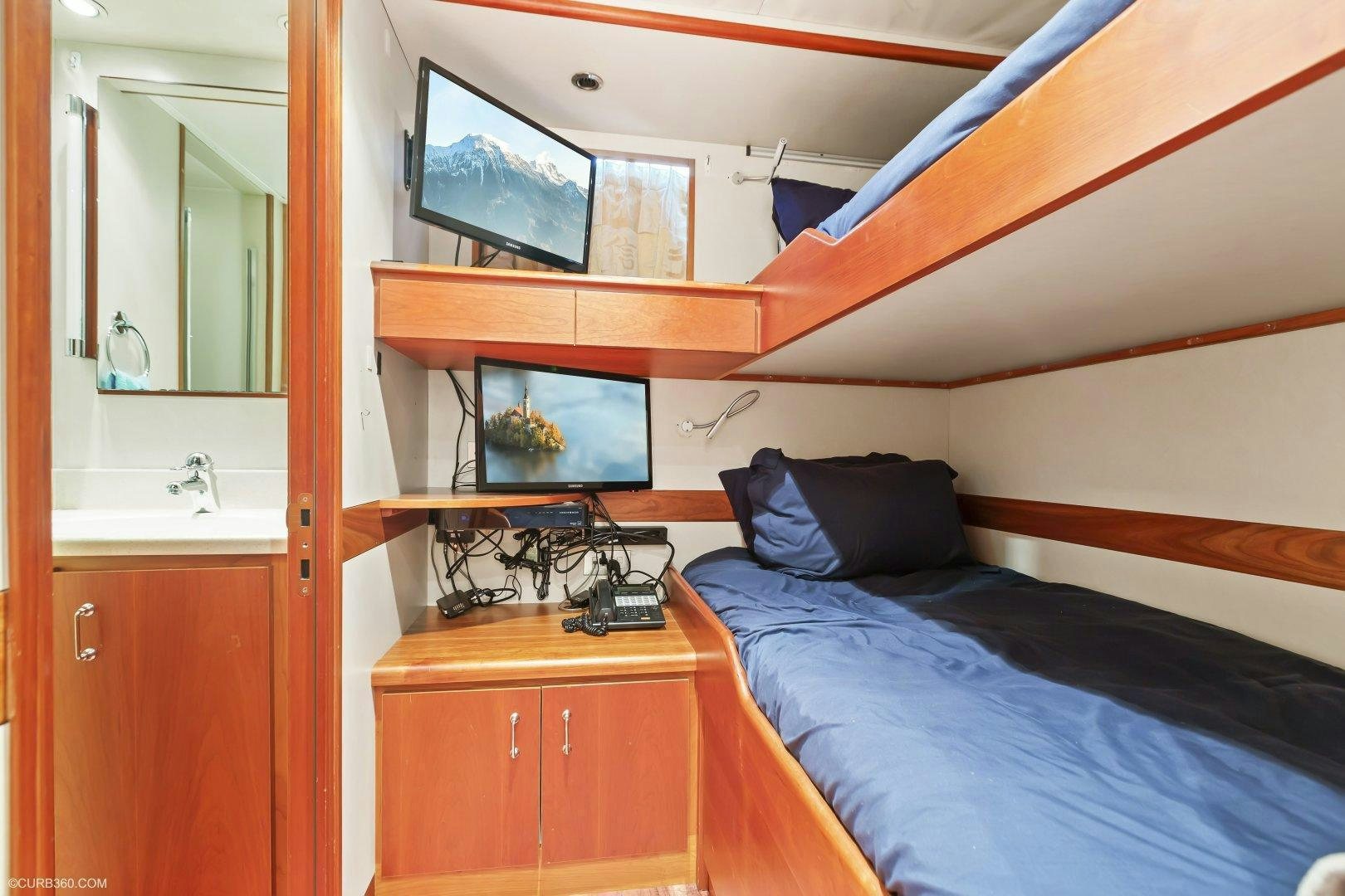 a bedroom with a bed and a mirror aboard APHRODITE Yacht for Sale