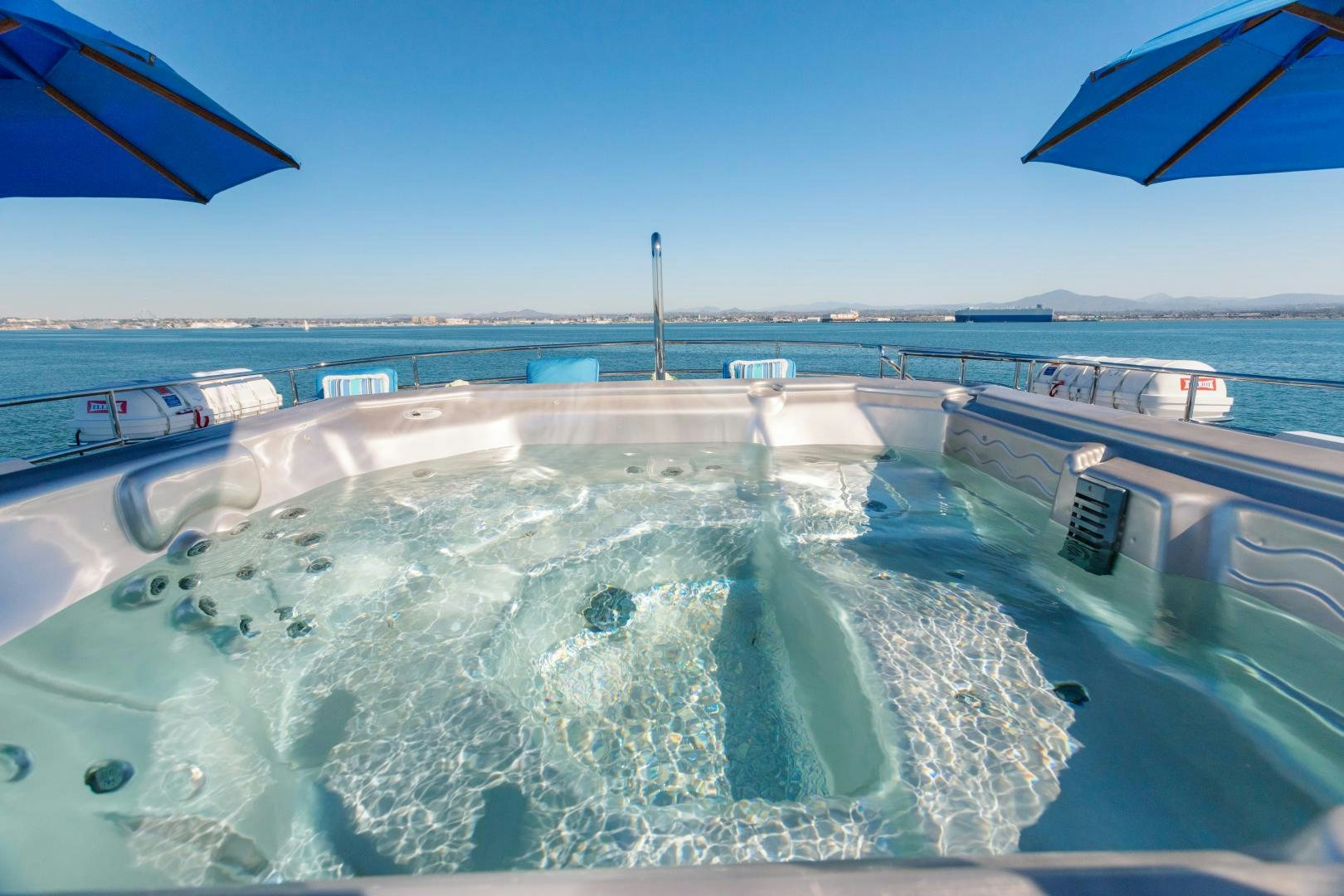 a pool of water with boats and buildings in the background aboard APHRODITE Yacht for Sale