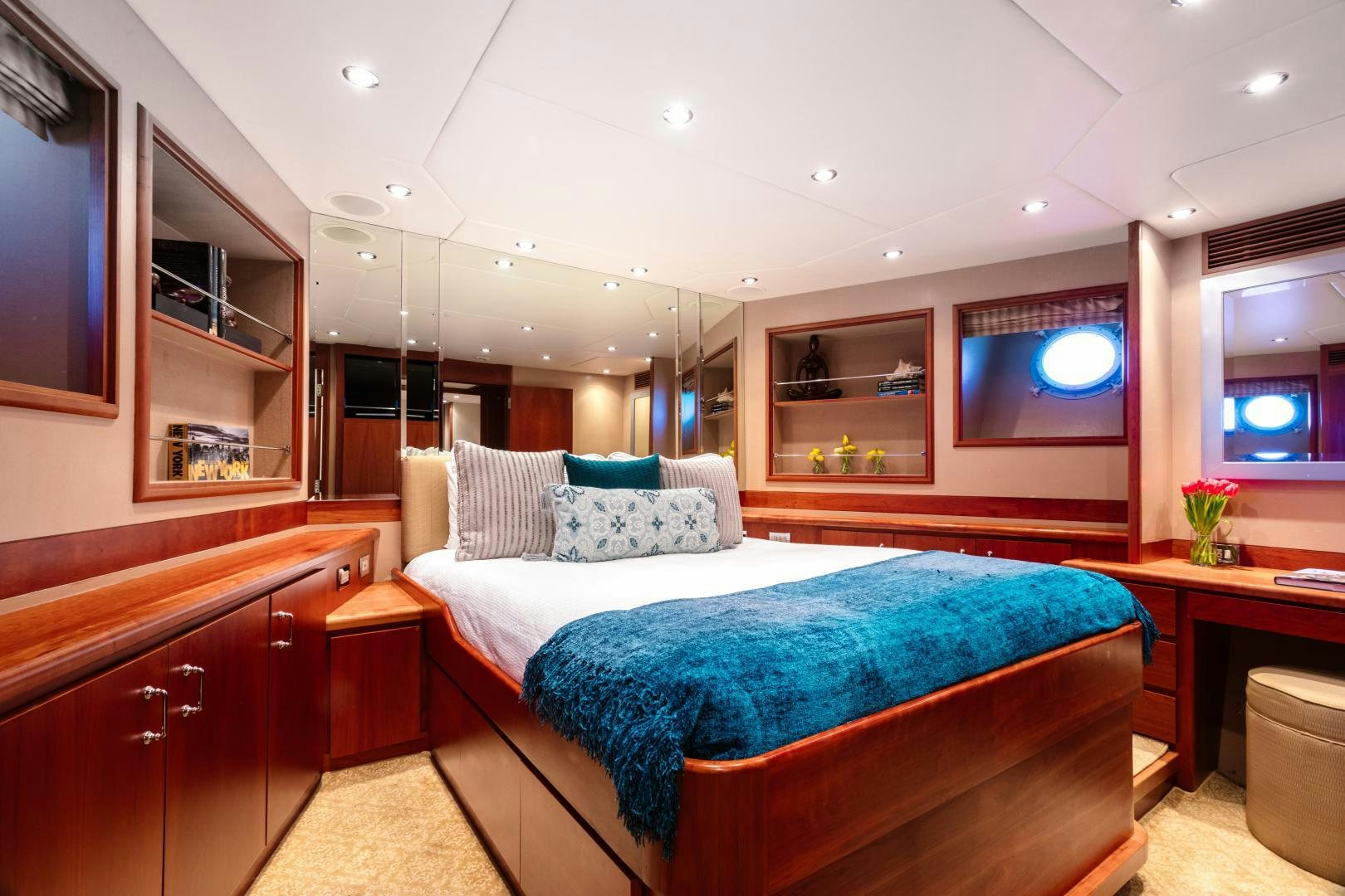 a bedroom with a bed and a desk aboard APHRODITE Yacht for Sale