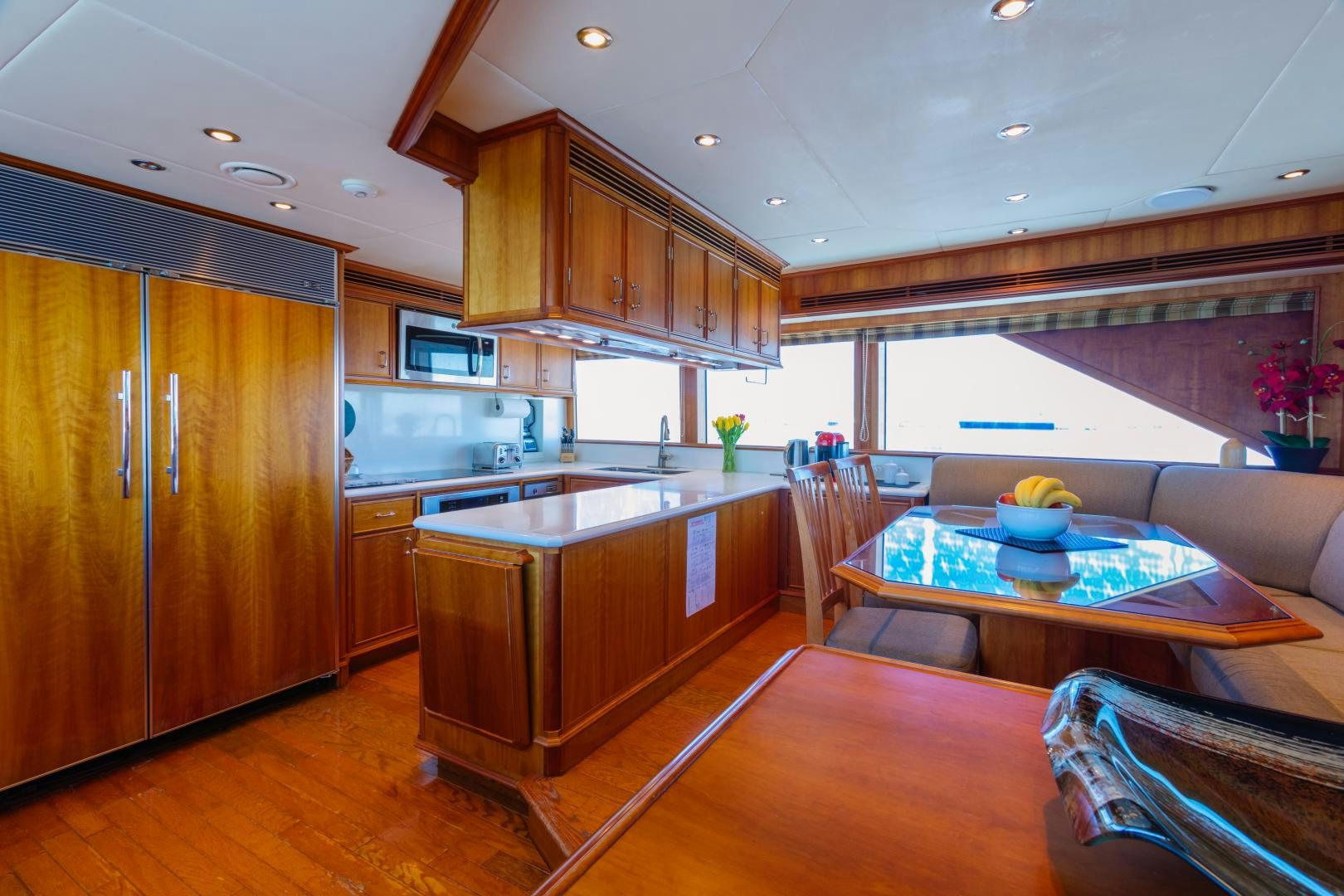 a kitchen with wooden cabinets aboard APHRODITE Yacht for Sale
