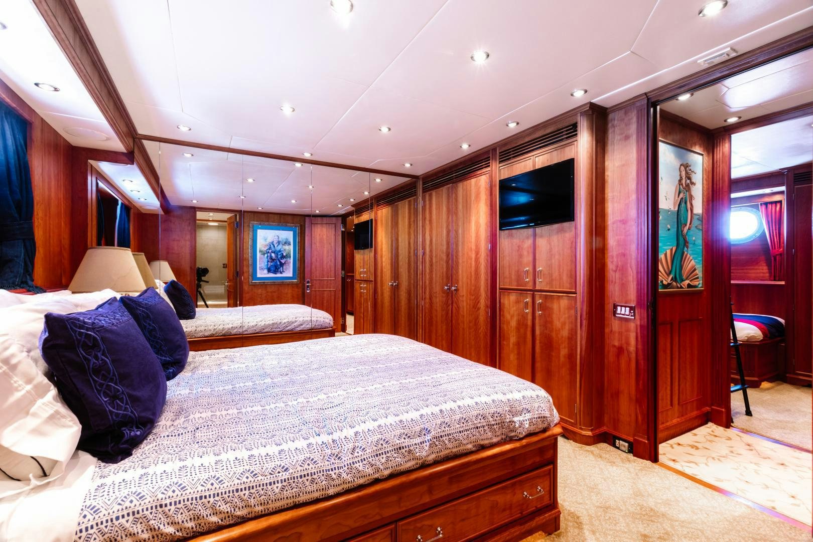 a bedroom with a bed and a wood wall aboard APHRODITE Yacht for Sale
