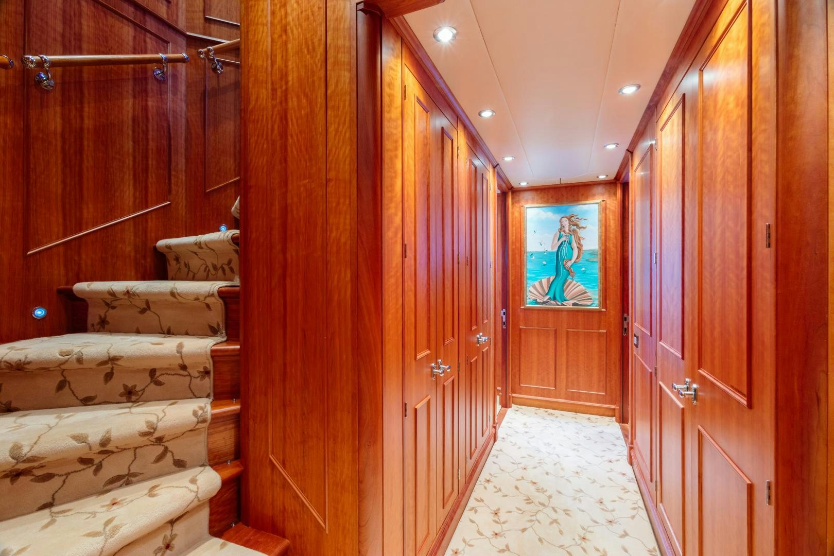 a room with wooden walls and a painting on the wall aboard APHRODITE Yacht for Sale