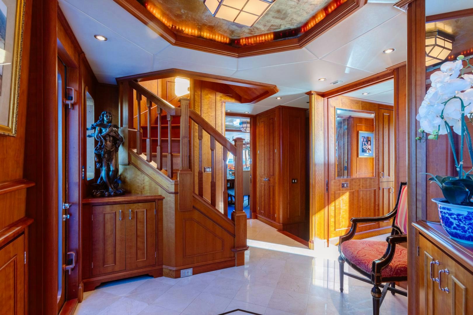 a room with a wood door and a chair and a wood door aboard APHRODITE Yacht for Sale