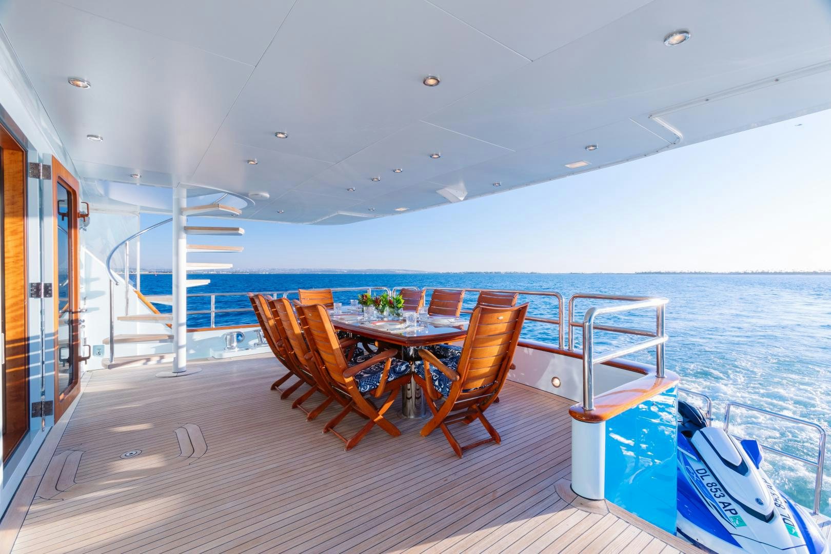 a large pool with a table and chairs aboard APHRODITE Yacht for Sale