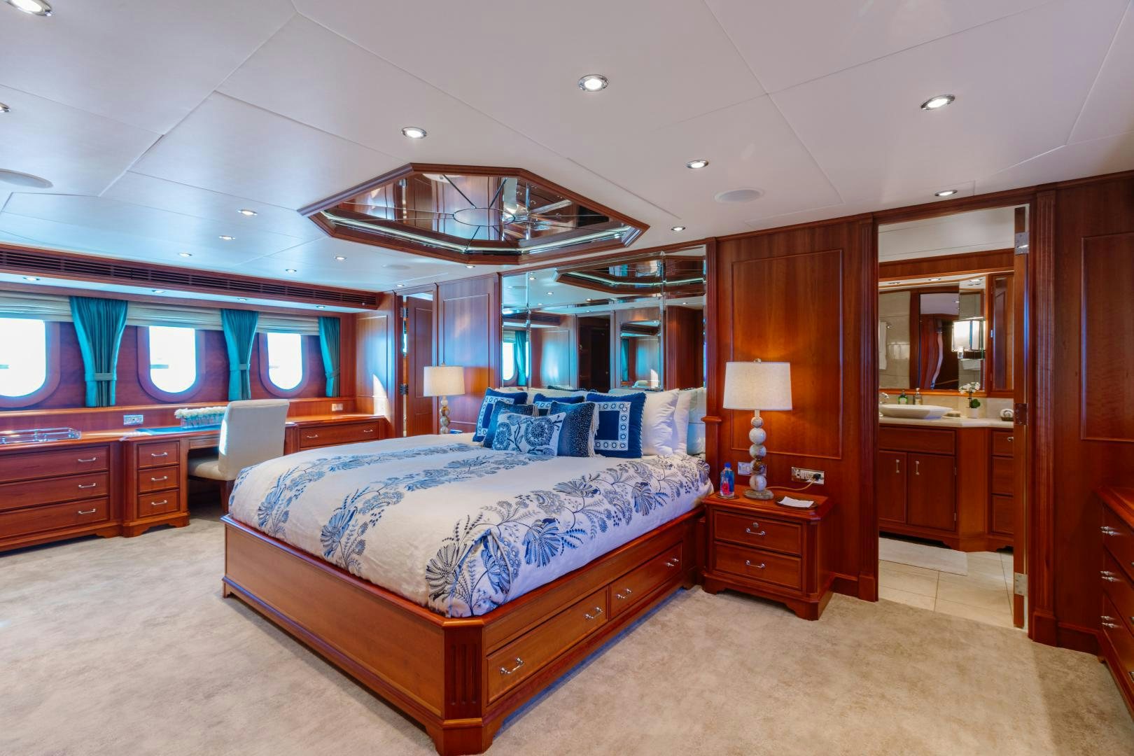 a bedroom with a bed and a desk aboard APHRODITE Yacht for Sale