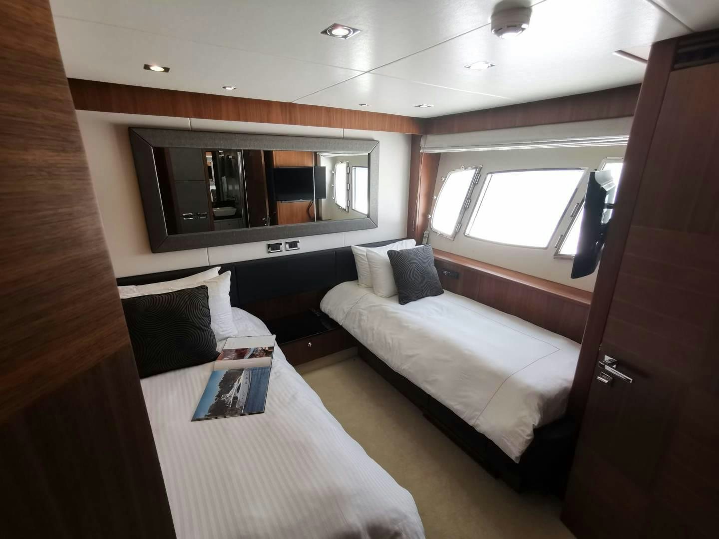 a room with a bed and a television aboard SYDNEY Yacht for Sale