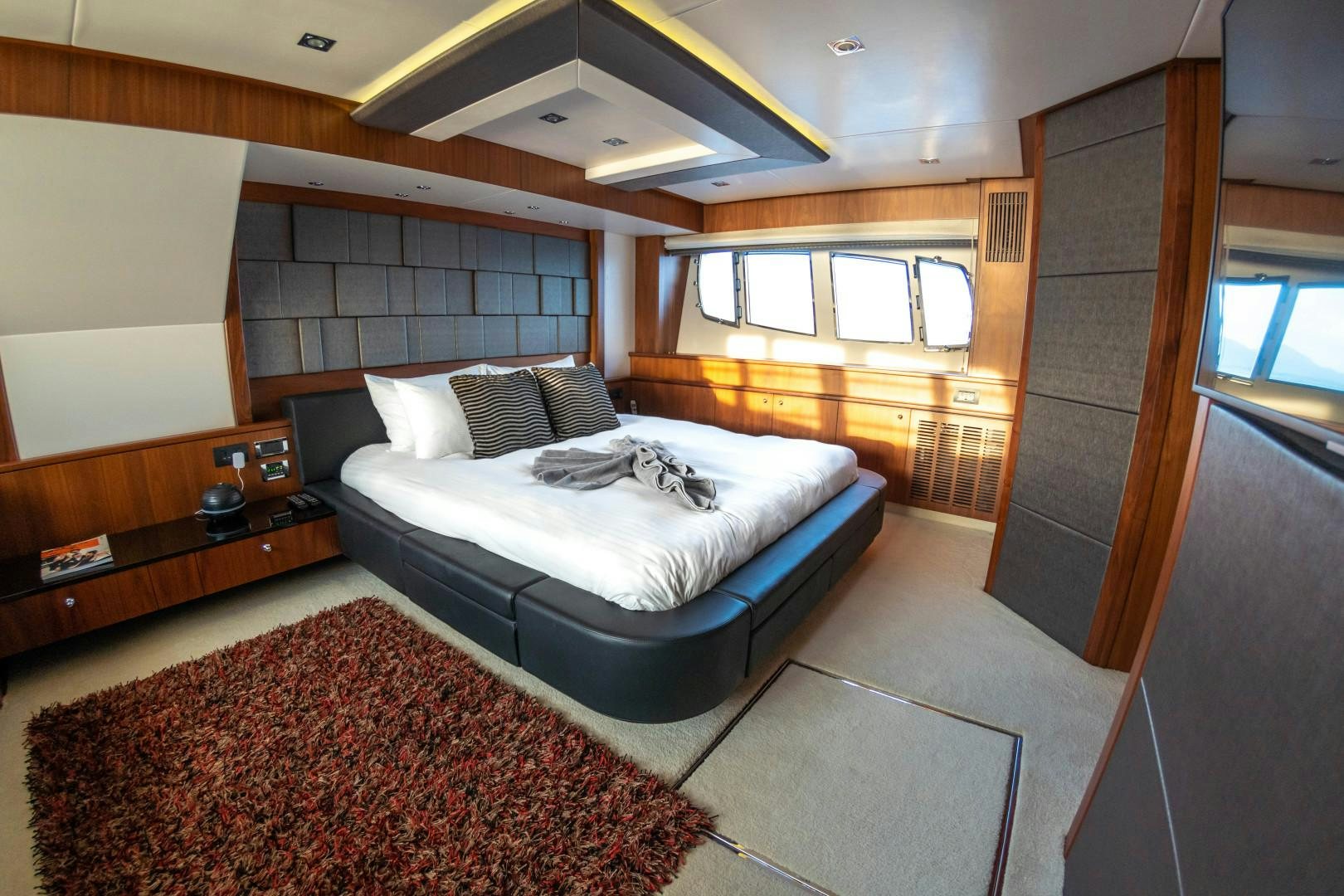 a bedroom with a bed and a window aboard SYDNEY Yacht for Sale