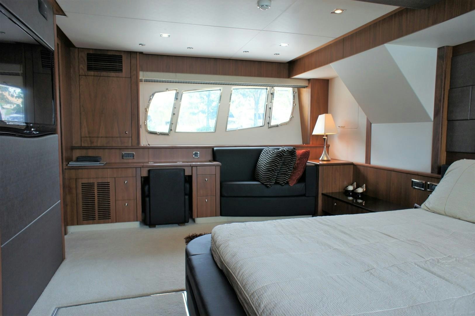 a bedroom with a bed and a couch aboard SYDNEY Yacht for Sale