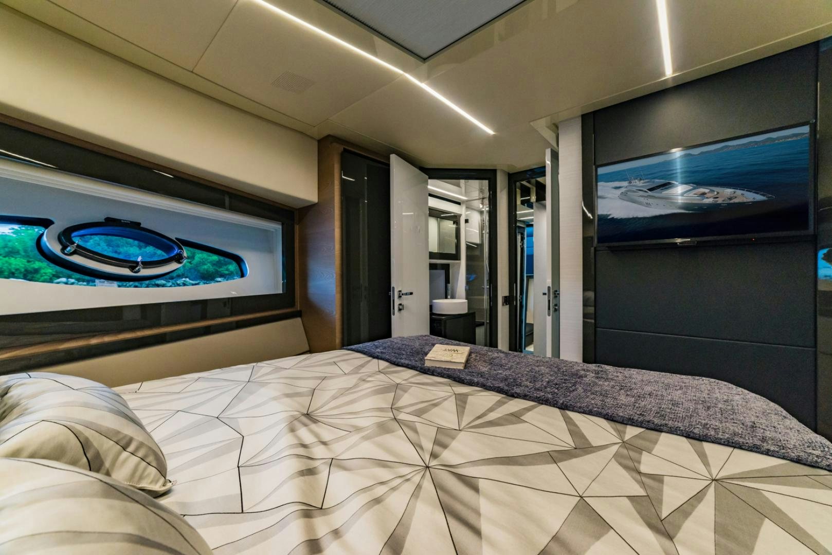 a bed with a white comforter and a blue eye aboard BAD DADDY Yacht for Sale