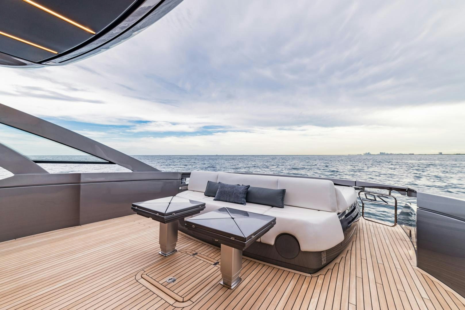 a large lounge chair on a deck overlooking a body of water aboard BAD DADDY Yacht for Sale