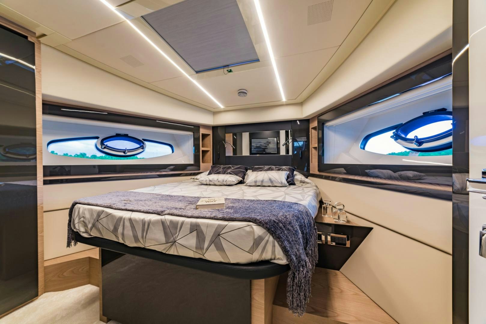 a bedroom with a large television aboard BAD DADDY Yacht for Sale