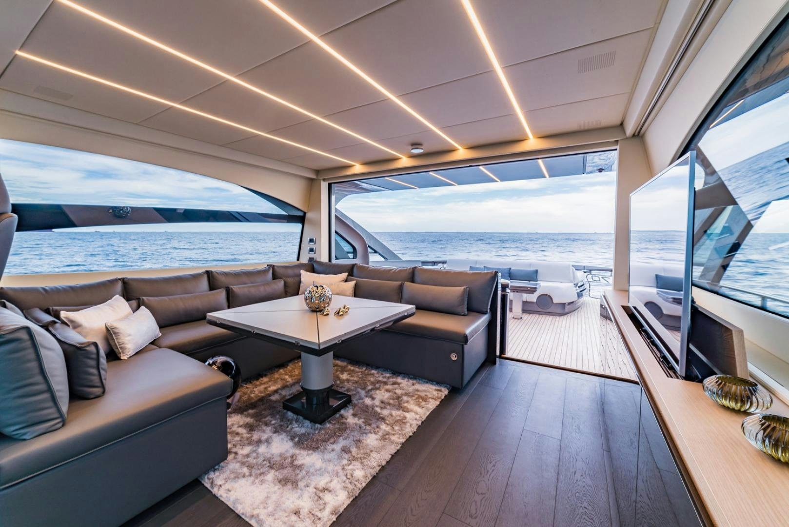 a living room with a large ocean aboard BAD DADDY Yacht for Sale