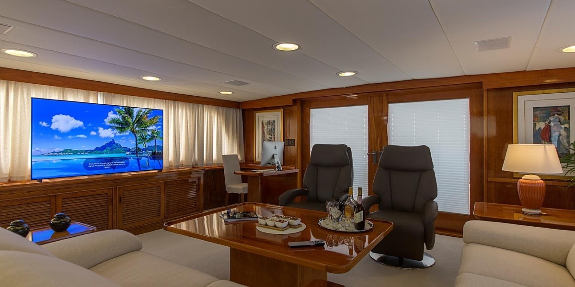 a living room with a large screen aboard ADRIATIC ESCAPE Yacht for Sale