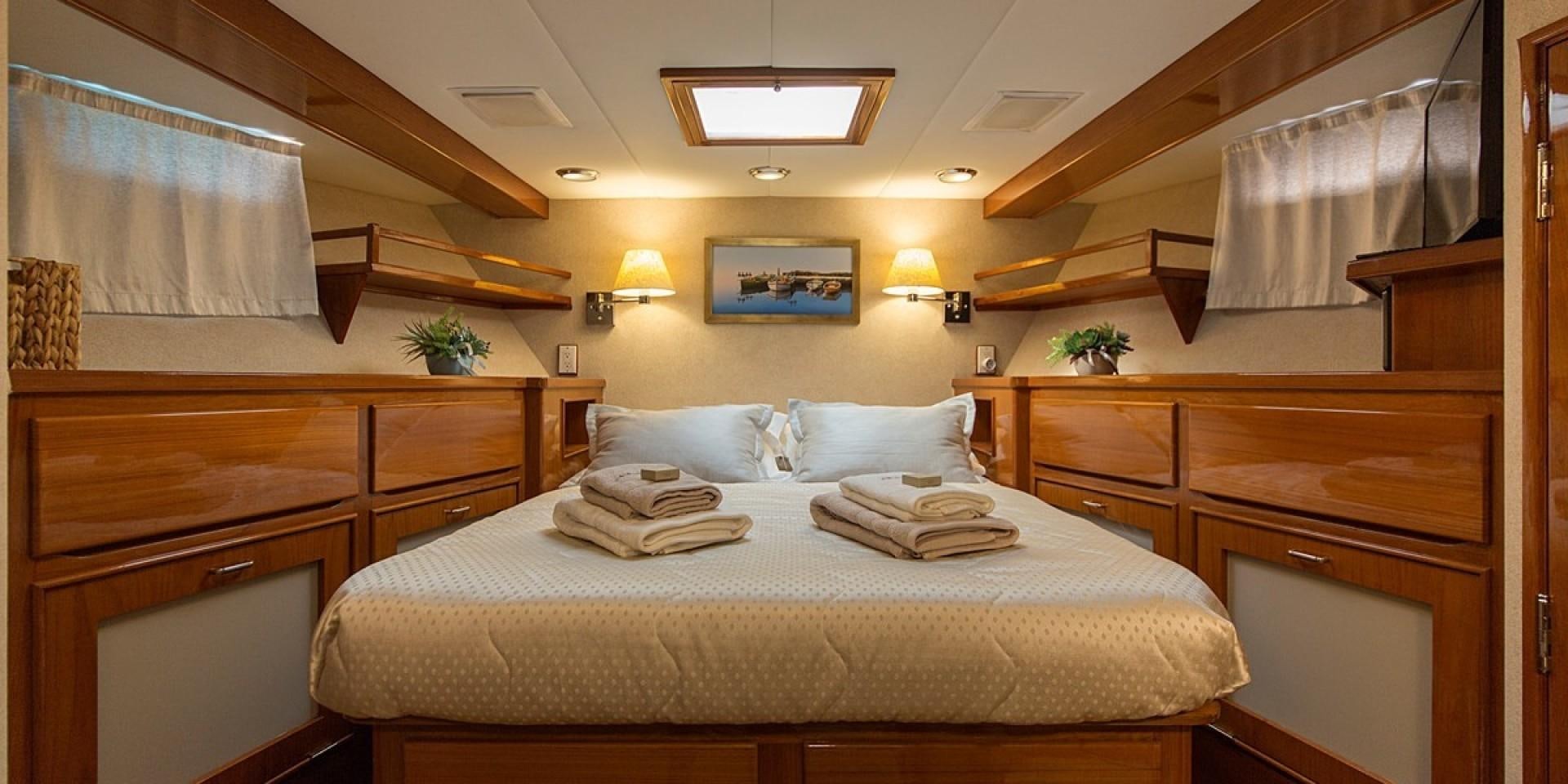a bedroom with a bed and cabinets aboard ADRIATIC ESCAPE Yacht for Sale