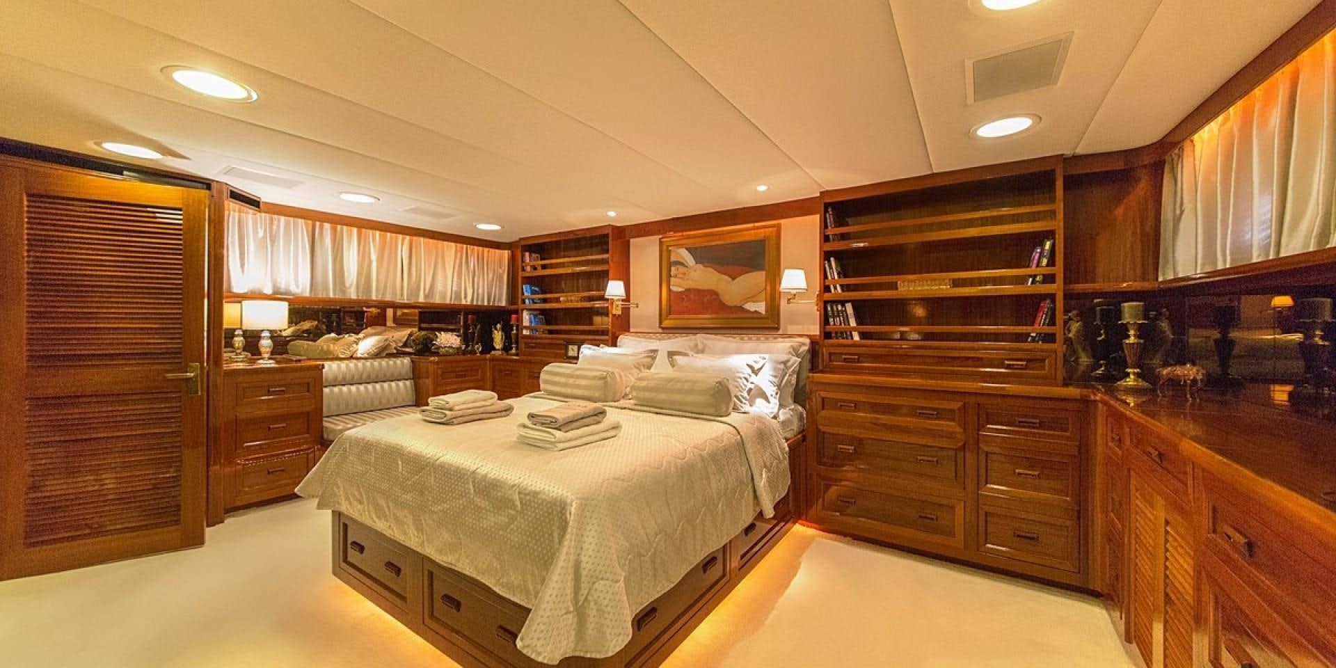 a room with wooden cabinets and a bed aboard ADRIATIC ESCAPE Yacht for Sale